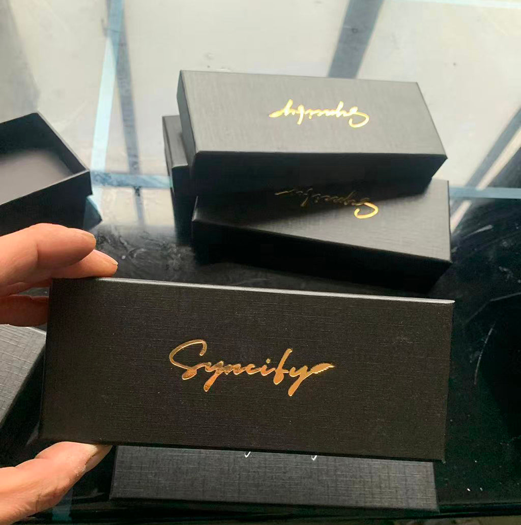 Black lid-and-base pen boxes with gold script marks