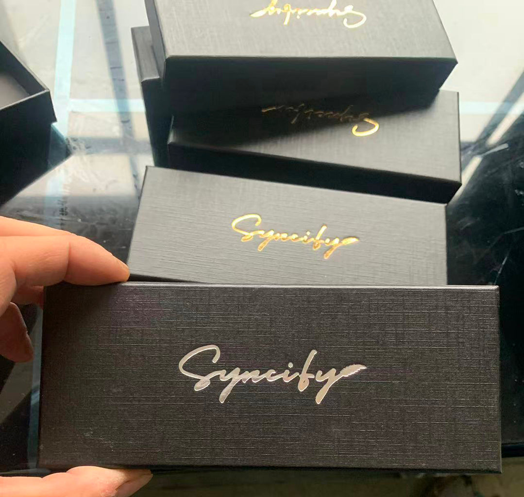 Black pen boxes with gold script marks