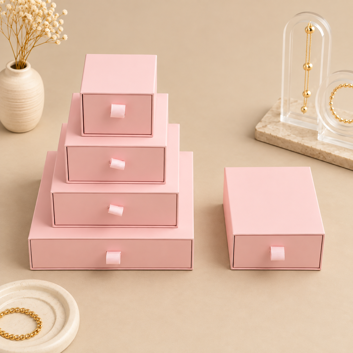 Pink paper drawer jewelry boxes shown in the five size options