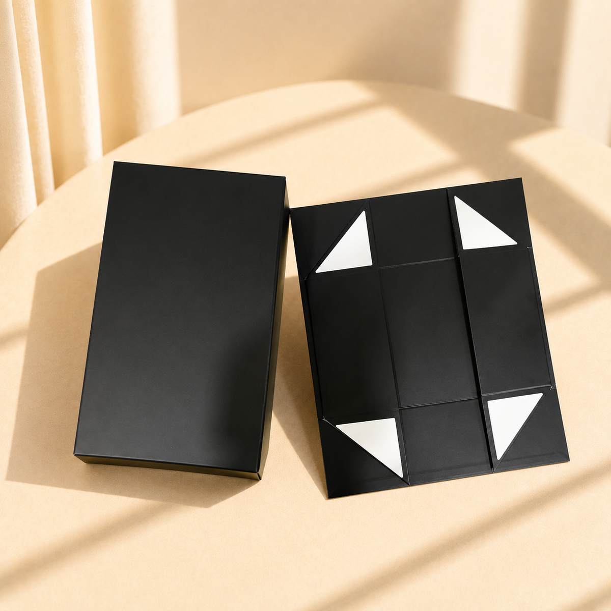 Black collapsible rigid gift box shown assembled and flat-packed
