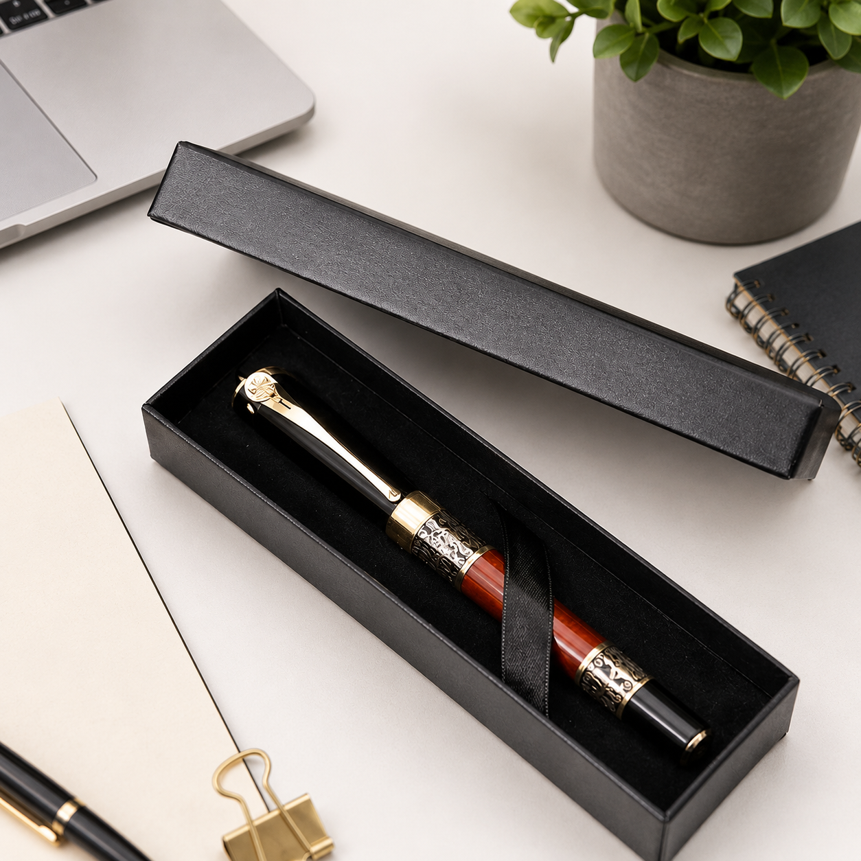 Black magnetic pen gift box holding a black and red fountain pen