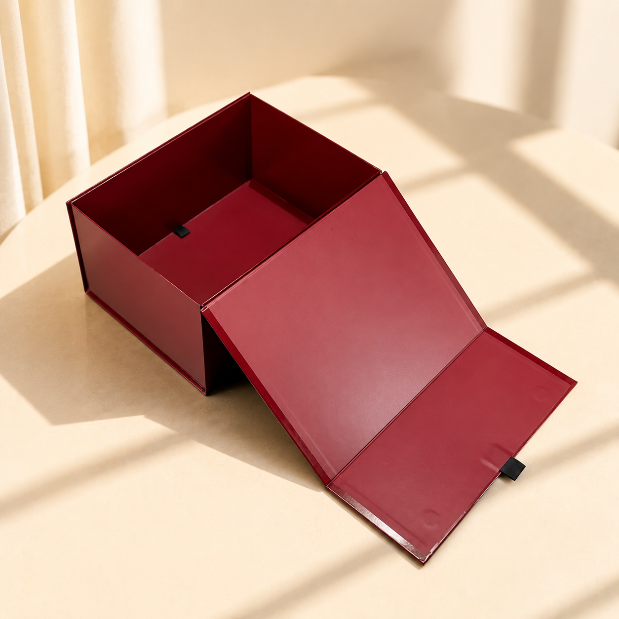 Burgundy collapsible magnetic gift box shown open and flat