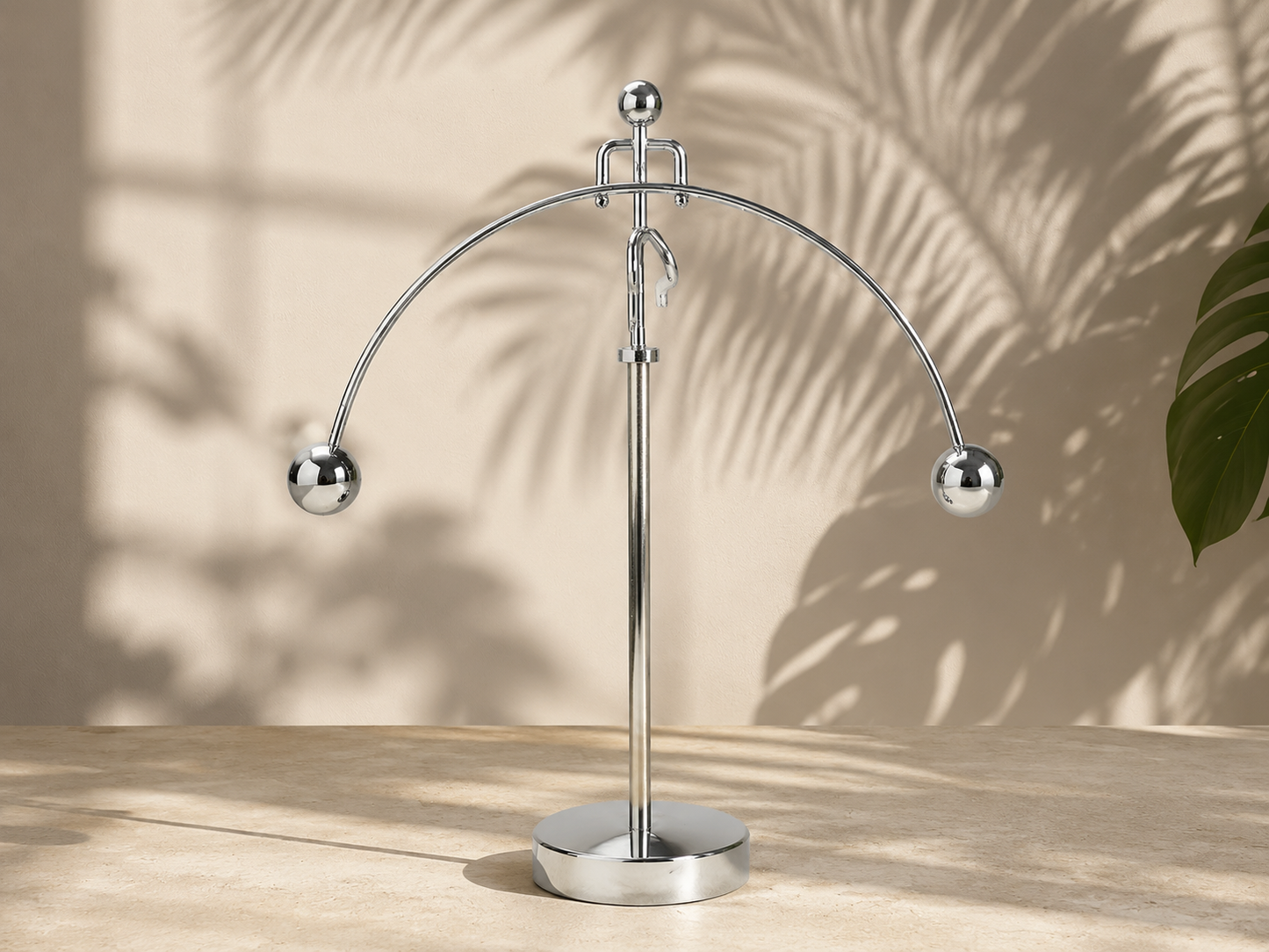 A premium stainless steel kinetic motion balance toy swinging smoothly on a luxury executive office desk, capturing perfect metallic reflections and minimalist physical art aesthetic.