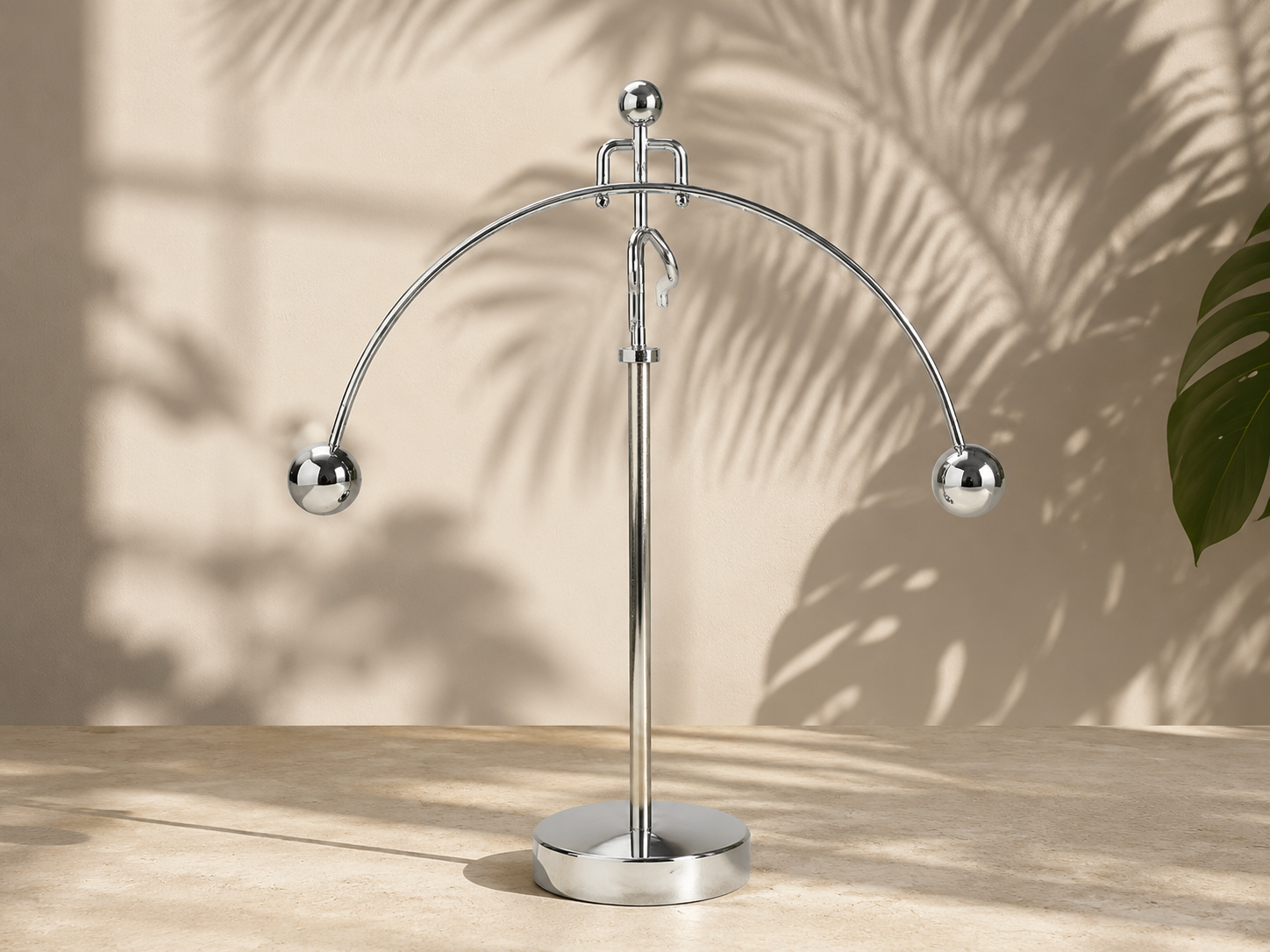 A premium stainless steel kinetic motion balance toy swinging smoothly on a luxury executive office desk, capturing perfect metallic reflections and minimalist physical art aesthetic.
