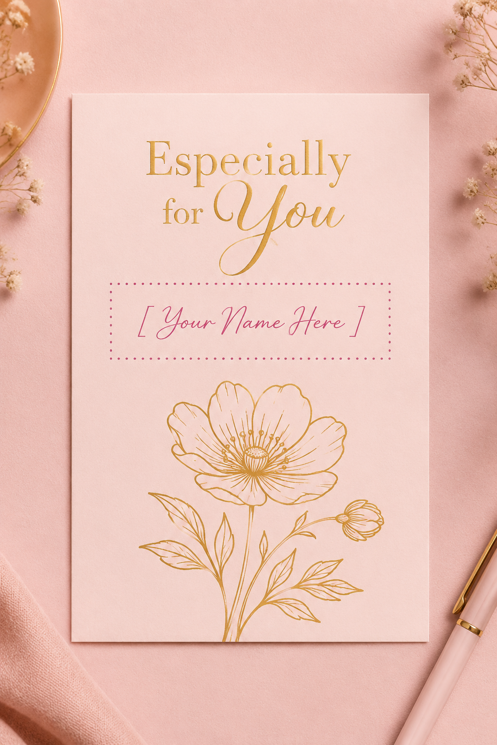 A single-sided romantic blush pink greeting card mockup in A6 format, featuring beautiful flat faux gold line art of a flower and an elegant dark pink dotted rectangular placeholder that reads '[ Your Name Here ]' for personalized custom name printing.