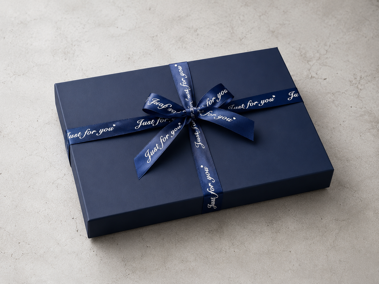 Rigid deep navy blue gift box cross-tied with a royal blue satin ribbon and custom Just For You cursive text.