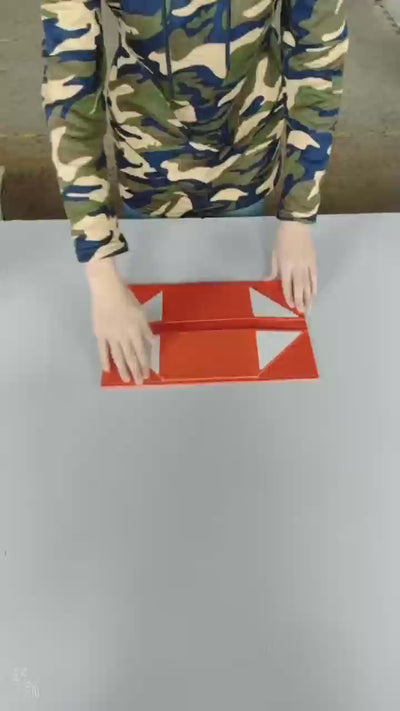 Red collapsible magnetic gift box being folded from flat panels