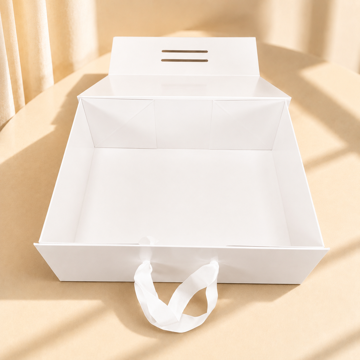 Open white paper shopping bag with ribbon handles