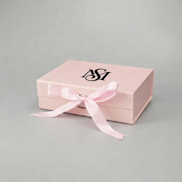 Black foil stamped logo on a pink rigid gift box