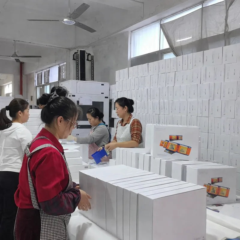 Packaging team assembling and preparing gift boxes